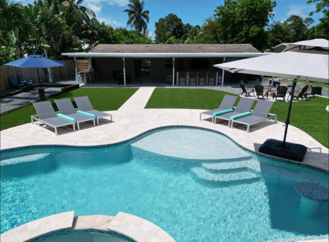 270 Northwest 36th Street Boca Raton, FL 33431 - Photo 12 of 82 a view of a house with backyard sitting area and garden