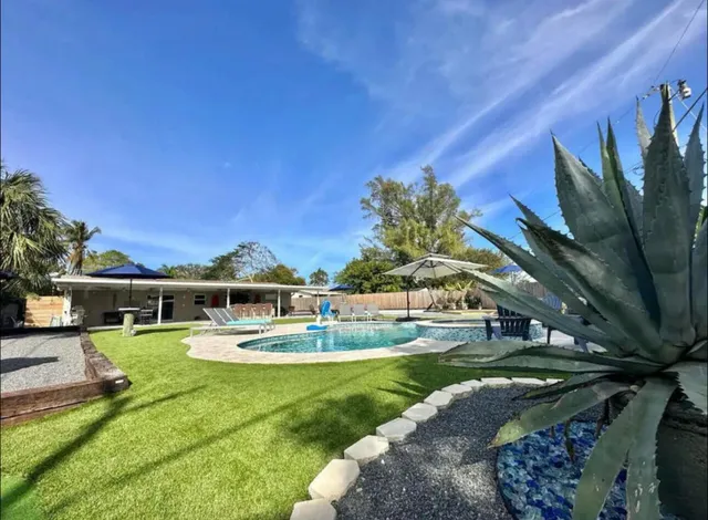 a view of a patio with couches and chairs with wooden floor