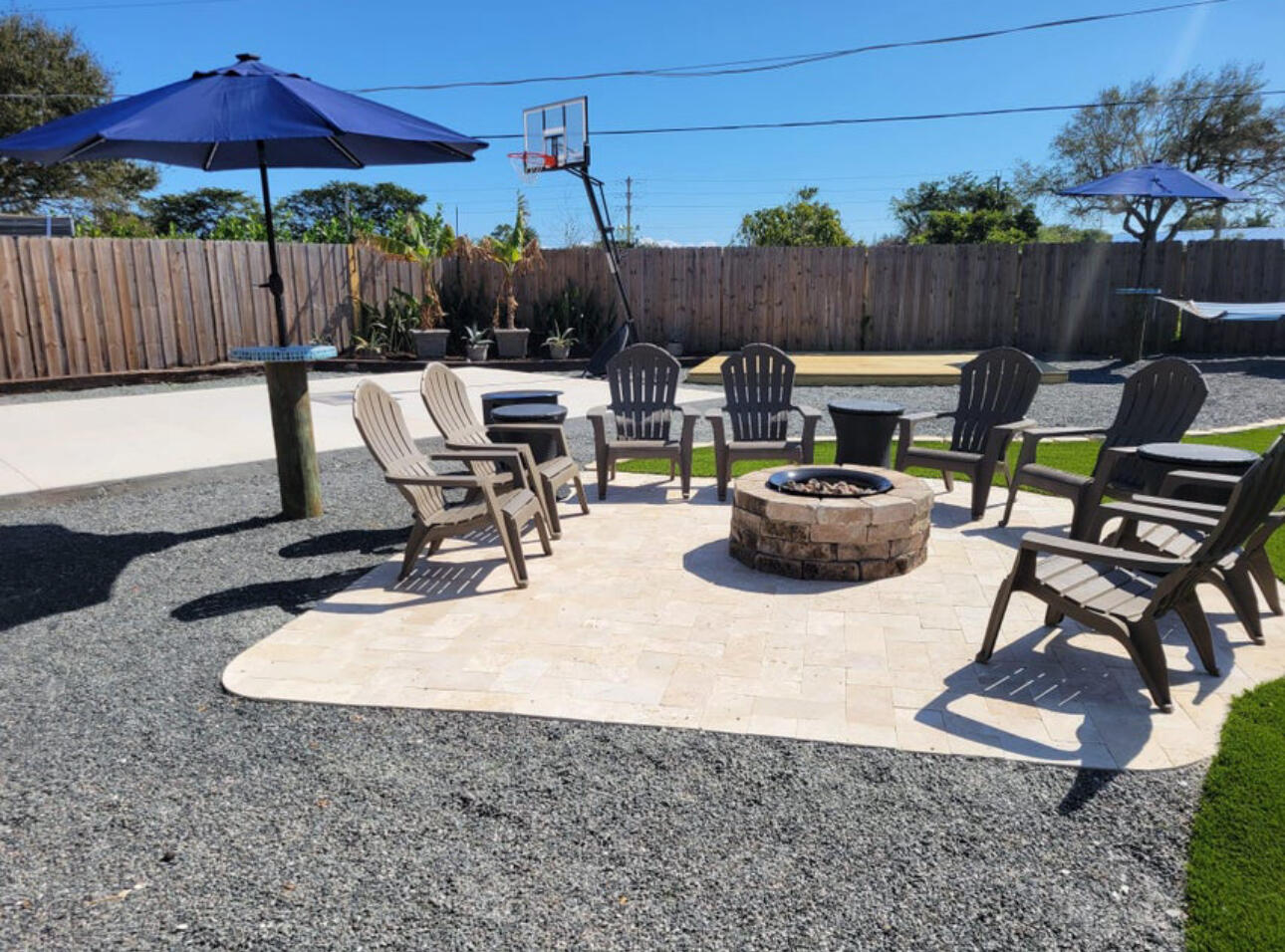 270 Northwest 36th Street Boca Raton, FL 33431 - Photo 18 of 82 a view of backyard with table and chairs under an umbrella with wooden fence