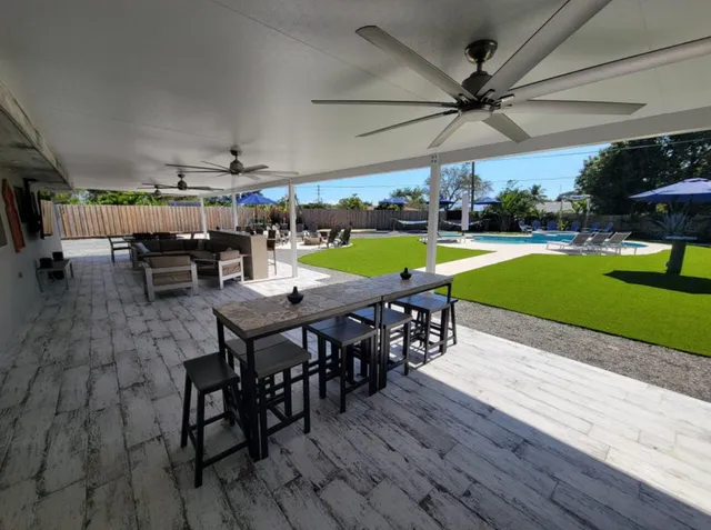 a view of a patio with a table and chairs
