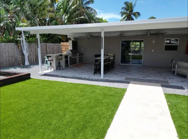 a kitchen with a stove a refrigerator a sink dishwasher with a dining table and chairs
