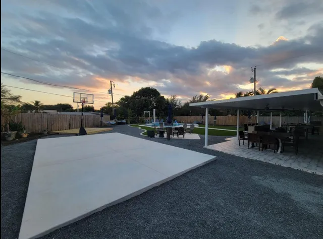 a bedroom with a bed a flat screen tv and a chandelier