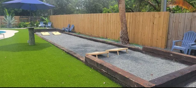 a bathroom with a sink a toilet a mirror and shower