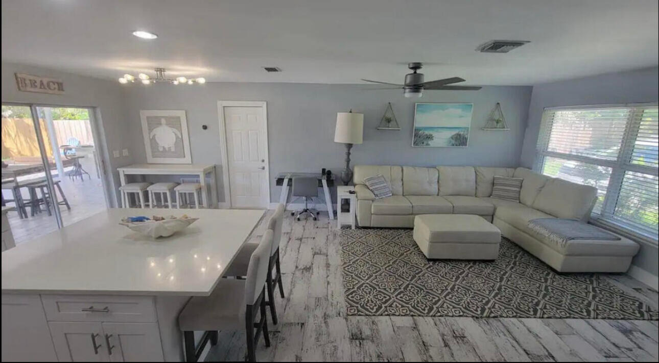 270 Northwest 36th Street Boca Raton, FL 33431 - Photo 53 of 82 a living room with furniture and a chandelier