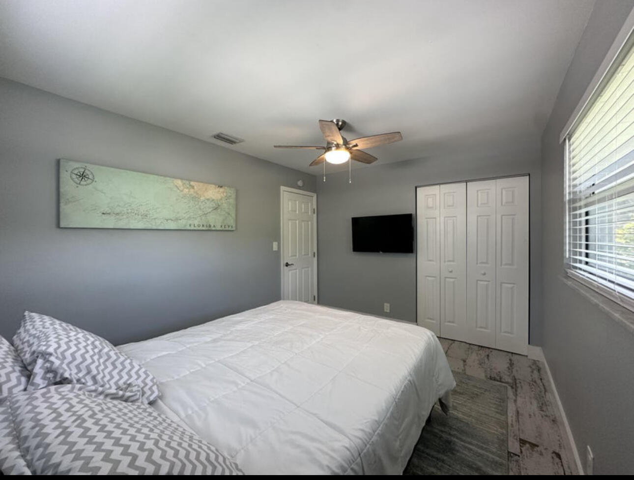 270 Northwest 36th Street Boca Raton, FL 33431 - Photo 65 of 82 a bedroom with a bed and a chandelier