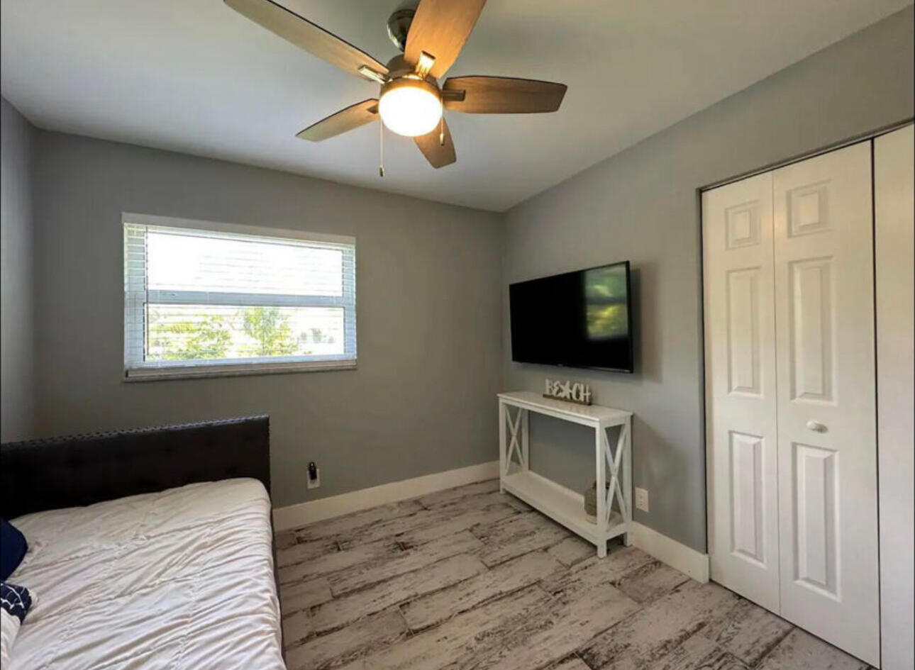 270 Northwest 36th Street Boca Raton, FL 33431 - Photo 70 of 82 a bedroom with a bed and a flat screen tv