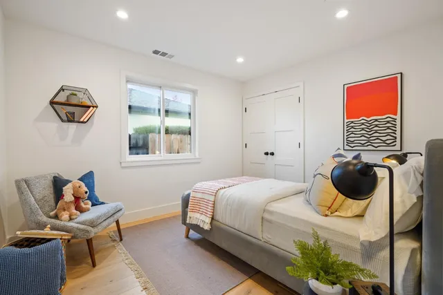 a bedroom with a bed and a window