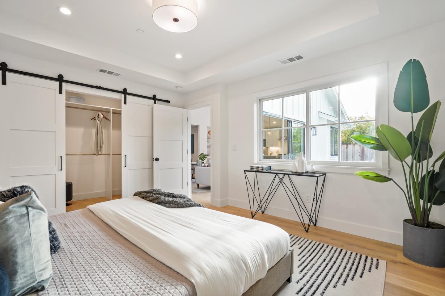 1642 Anamor Street Redwood City, CA 94061 - Photo 14 of 19 a bedroom with a bed and a potted plant