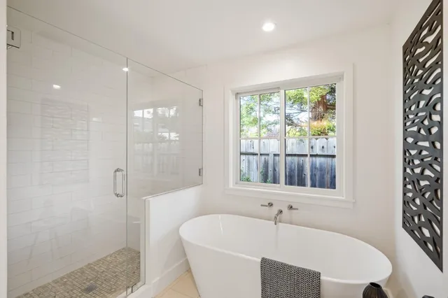 a bathroom with a bathtub and a shower