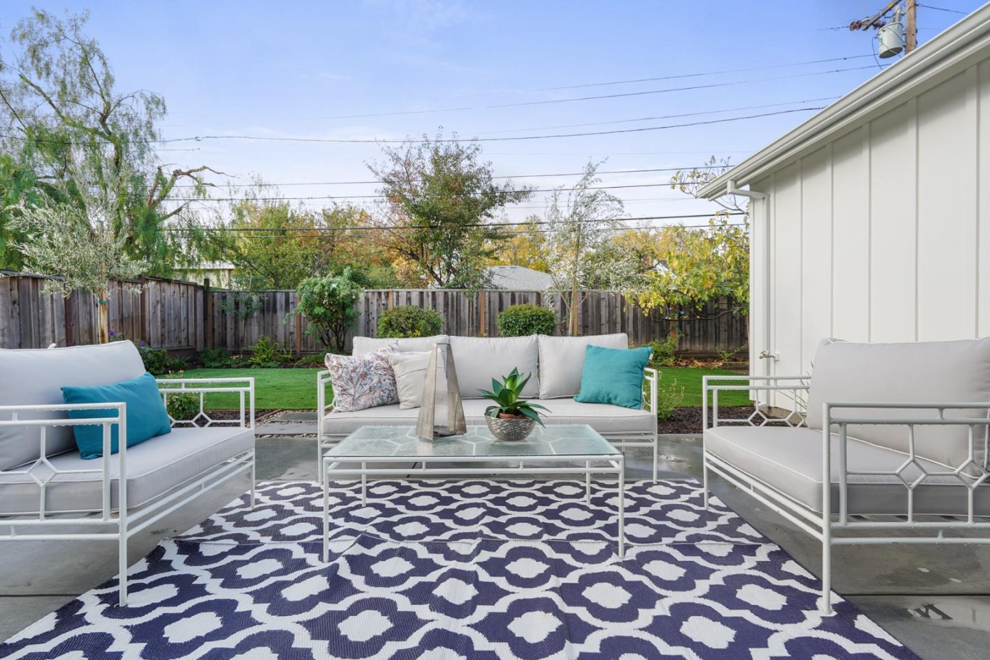 1642 Anamor Street Redwood City, CA 94061 - Photo 17 of 19 a view of a patio with a dining table and chairs