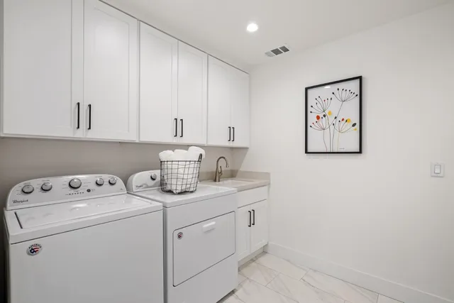 a view of cabinets with washer and dryer