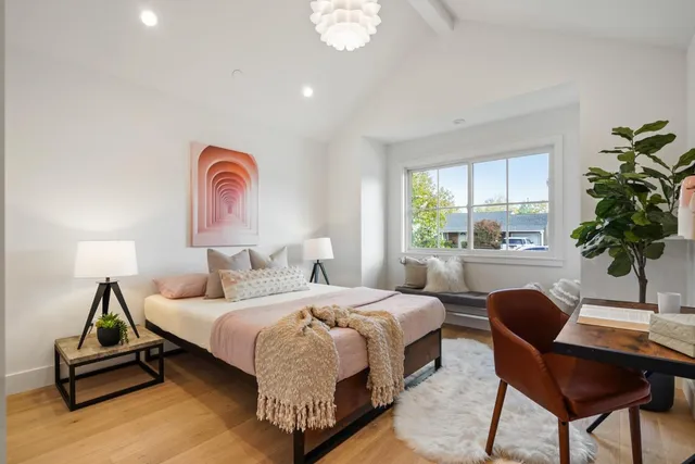 a bedroom with a bed and a potted plant