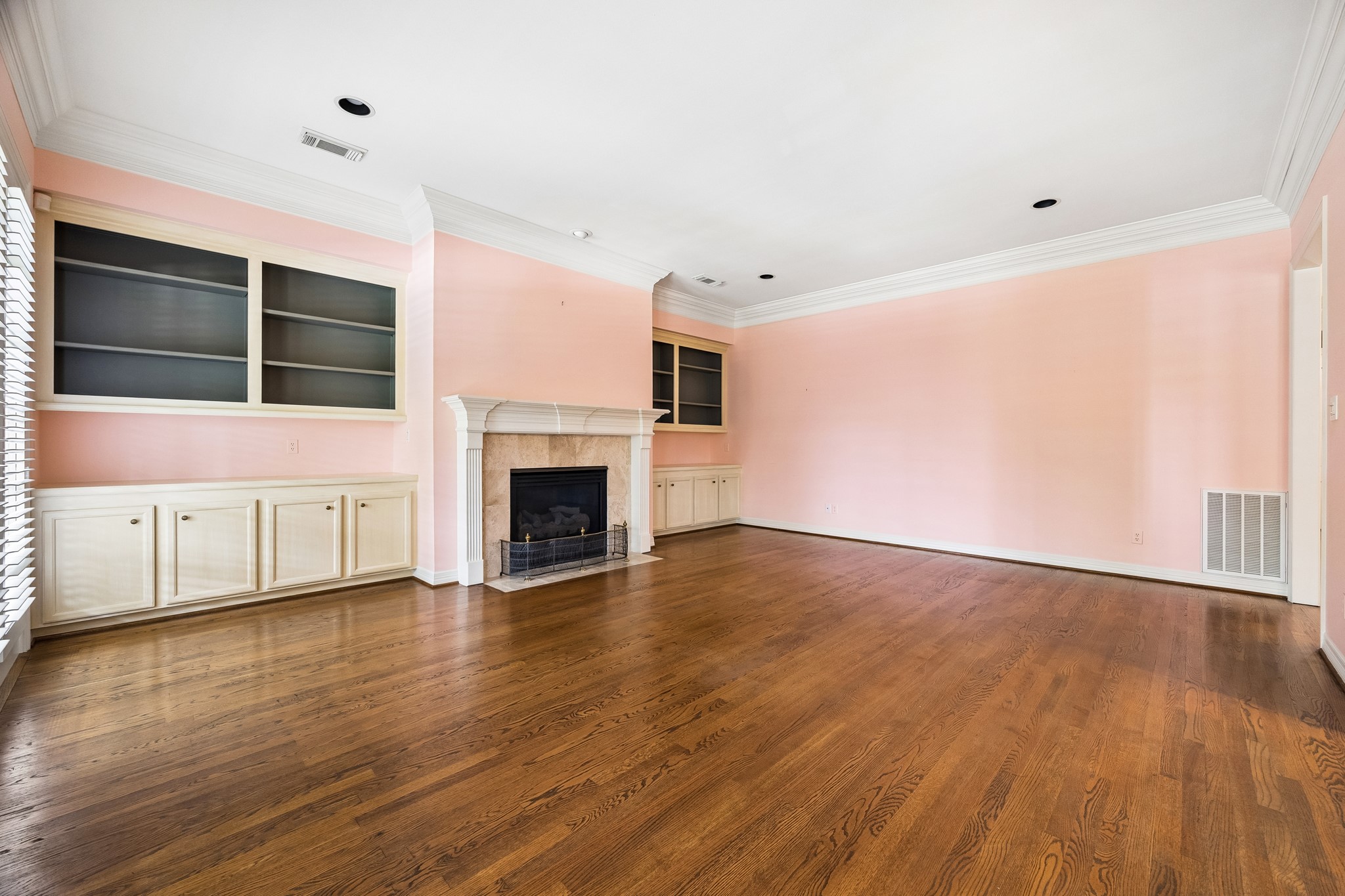 6022 Burgoyne Road Houston, TX 77057 - Photo 14 of 30 Large family room with hardwood floors, fireplace, custom built-ins, and an open layout ideal for everyday living.