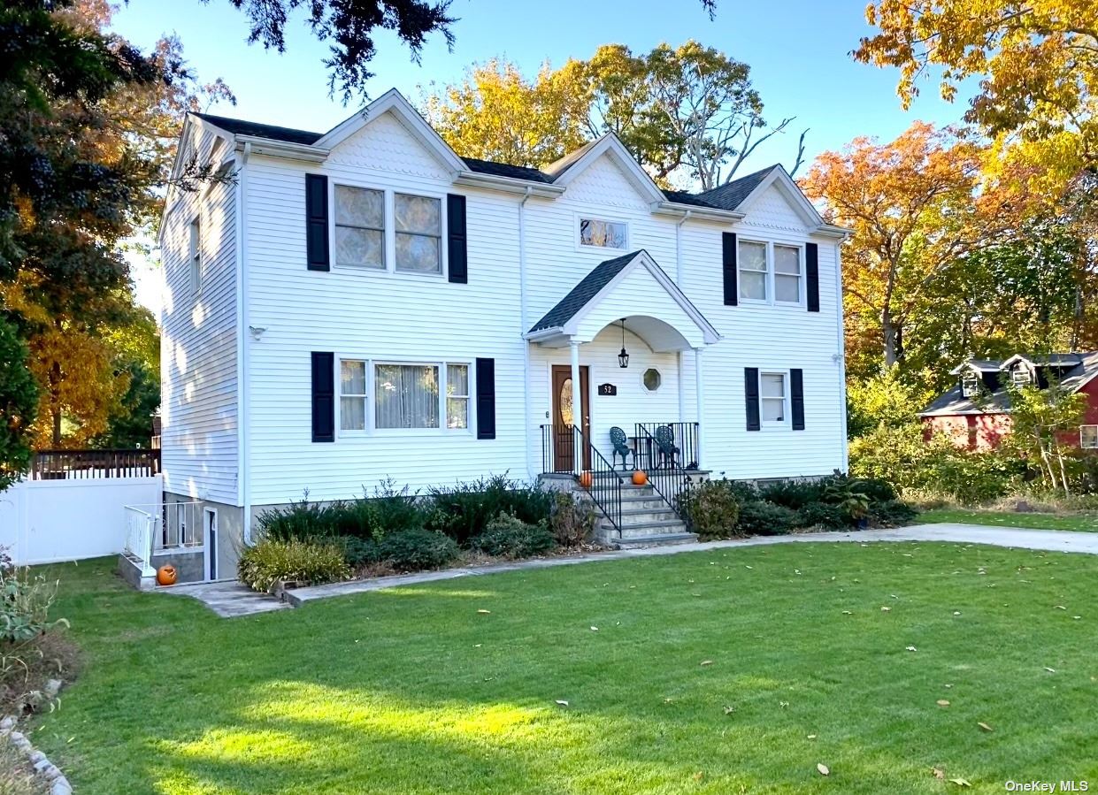 52 Palm Road Rocky Point, NY 11778 - Photo 1 of 1 a front view of a house with a garden and plants