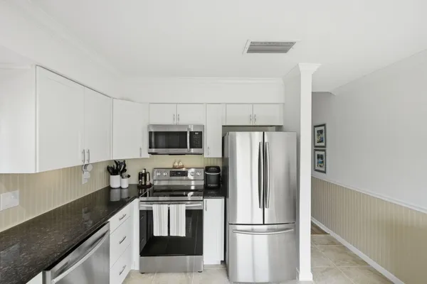 a kitchen with stainless steel appliances a refrigerator stove microwave and sink