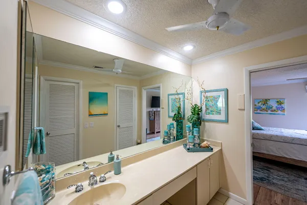 a en suite bathroom with a granite countertop sink and a mirror