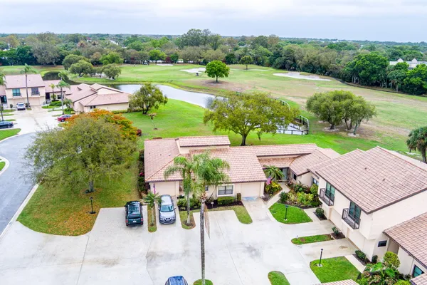 an aerial view of a house with garden space and street view