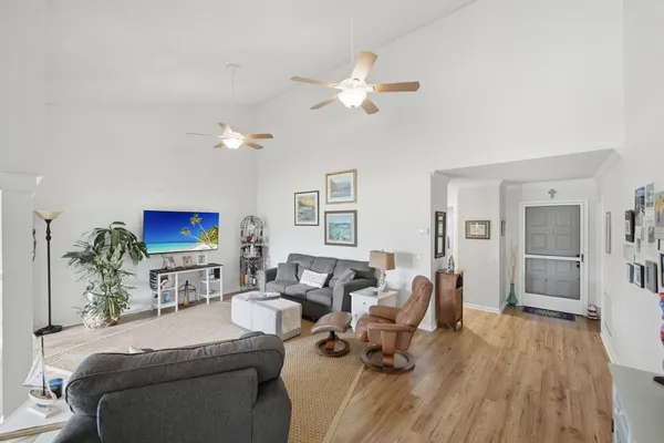 a living room with furniture a couch and a flat screen tv