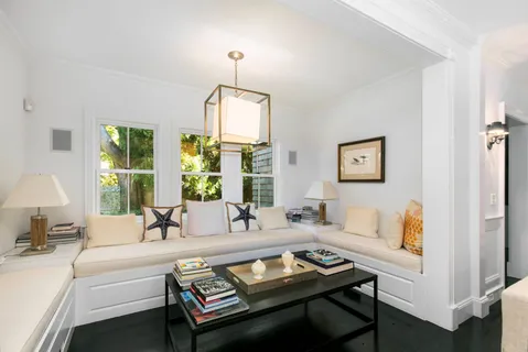 a living room with furniture and a chandelier