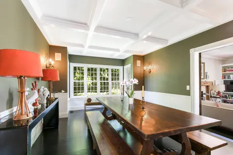 a view of a dining room with furniture and a large window