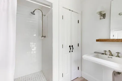 a bathroom with a sink and shower