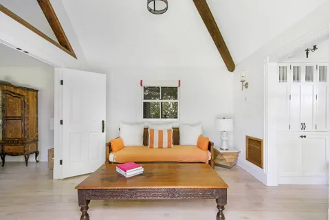 a bedroom with furniture and wooden floor