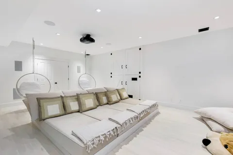 a spacious bedroom with a bed and a chandelier