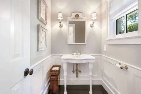 a bathroom with a sink a mirror and a window
