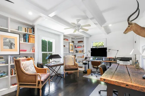 a living room with furniture a piano and a flat screen tv