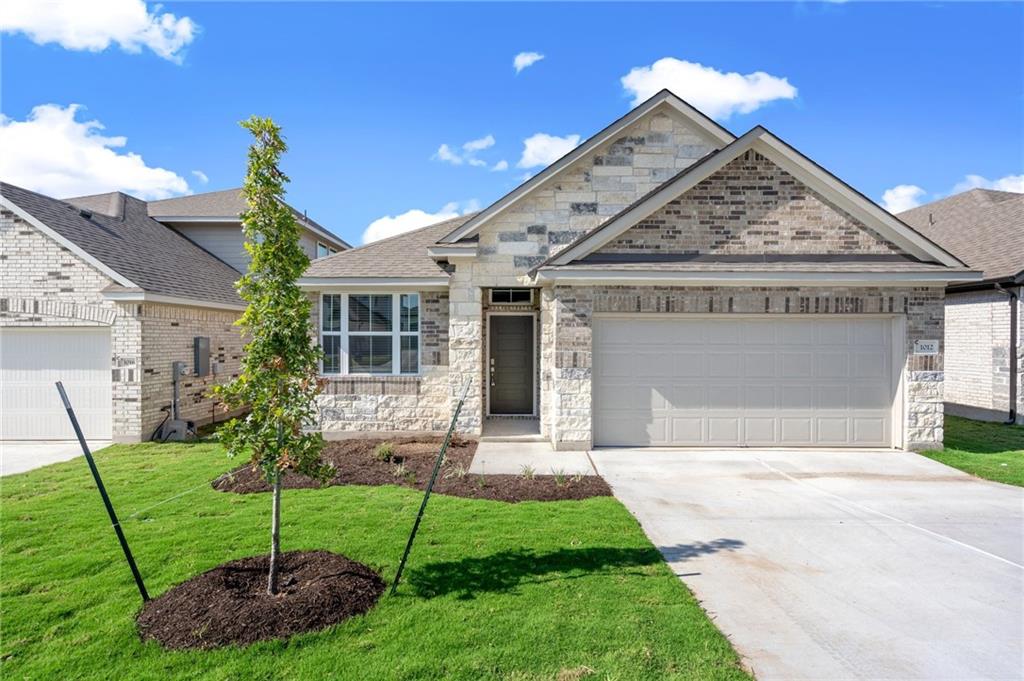 1012 Paddock Lane Georgetown, TX 78626 - Photo 2 of 15 Modern stone and brick facade creates a striking first impression for this inviting home.