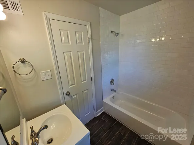 a bathroom with a bathtub a sink and a shower
