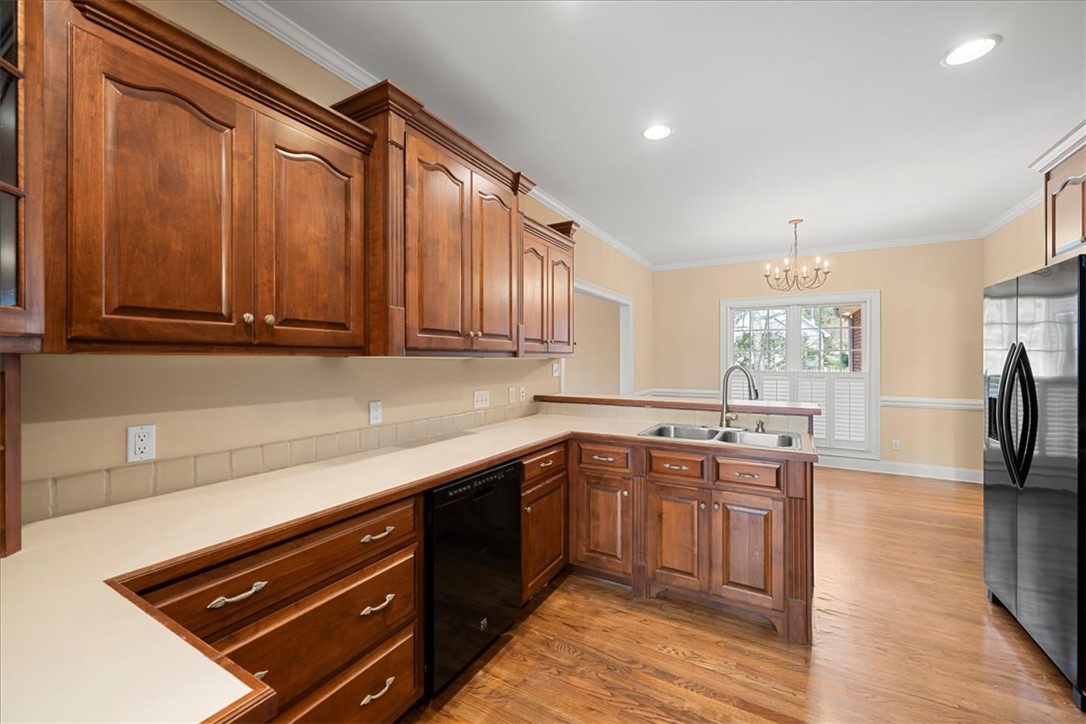 128 Cayman Way Anderson, SC 29621 - Photo 15 of 49 This spacious kitchen offers ample cabinetry, modern appliances, and a seamless flow into the dining area.