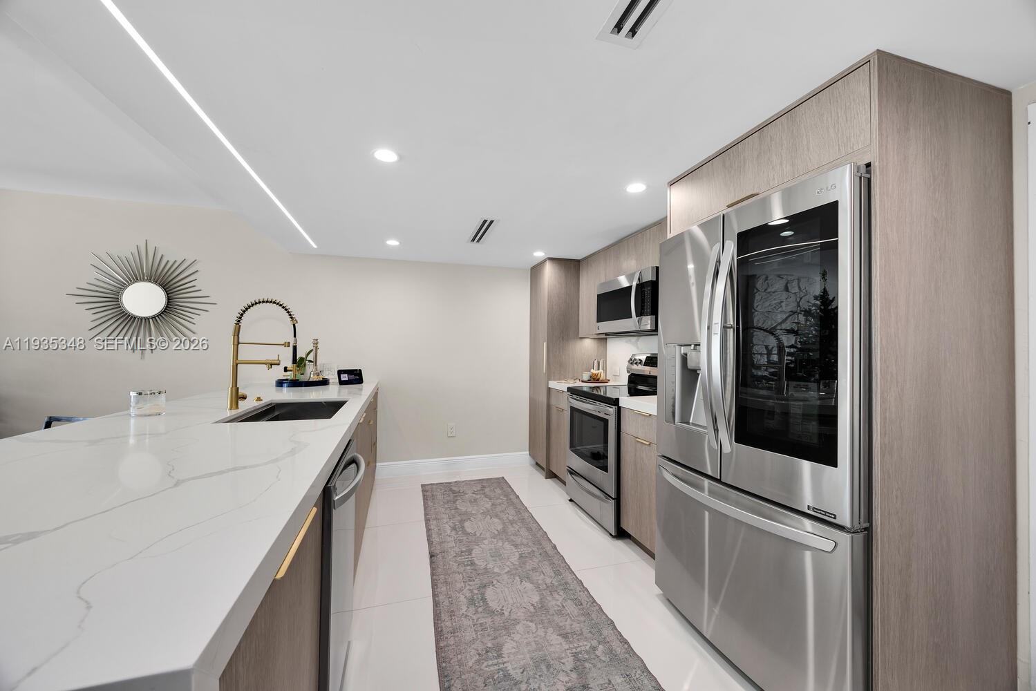 155 Ocean Ln Drive, Unit 413 Key Biscayne, FL 33149 - Photo 11 of 42 a kitchen with stainless steel appliances granite countertop a sink stove and refrigerator