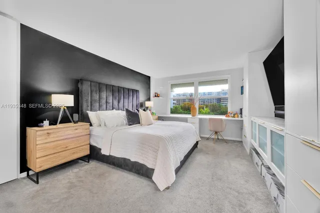 a bed room with a bed and a large window