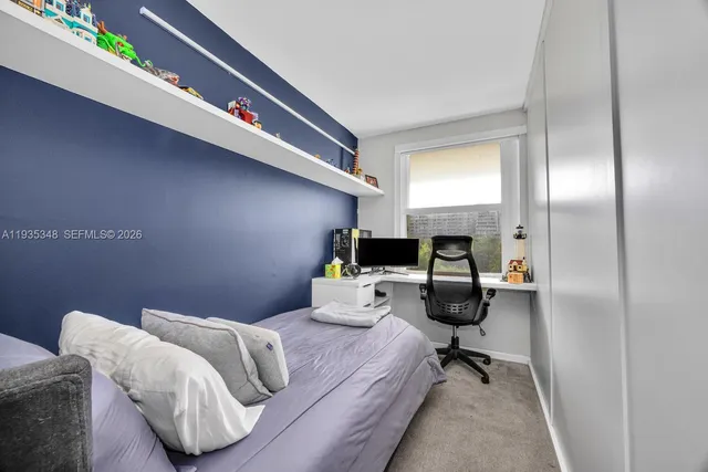 a bedroom with furniture and a mirror