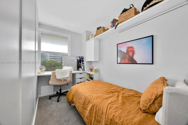 a bed room with a bed and a chair