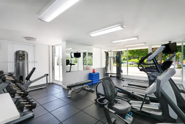 a room with gym equipment and windows