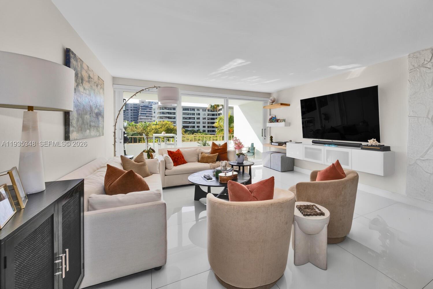 155 Ocean Ln Drive, Unit 413 Key Biscayne, FL 33149 - Photo 6 of 42 a living room with furniture and a flat screen tv