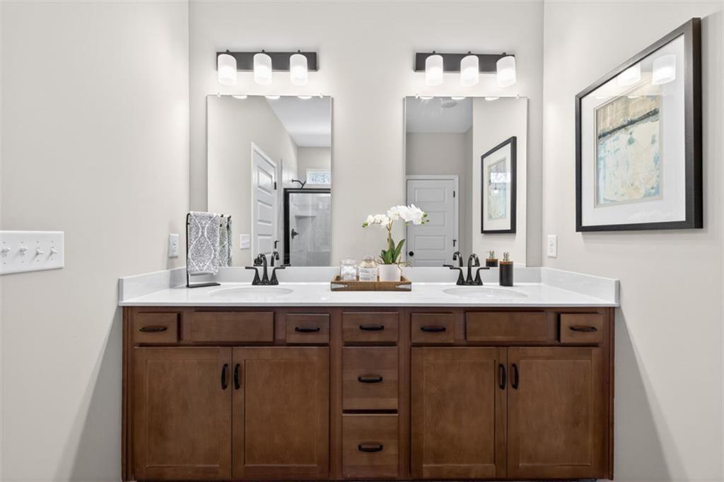 253 Shire Loop Calhoun, GA 30701 - Photo 33 of 38 a bathroom with double sink and a mirror