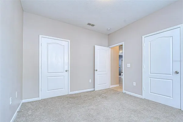 a view of an empty room and closet area