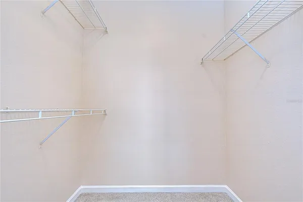 a backyard of a house with fountain table and chairs