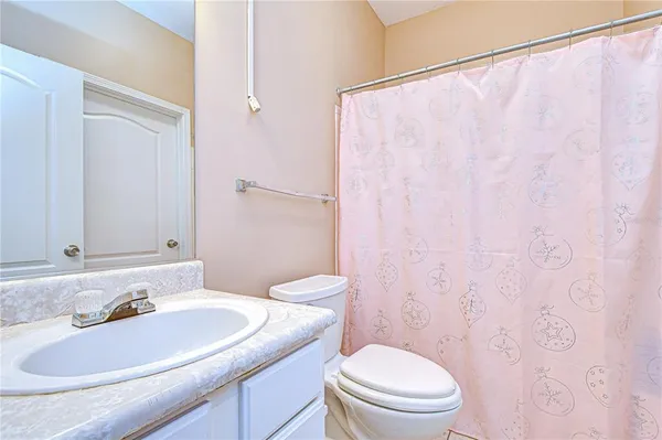 a houses view and a car parked in front of white house