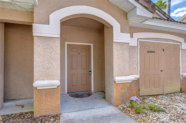 a view of an empty room with window and cabinet