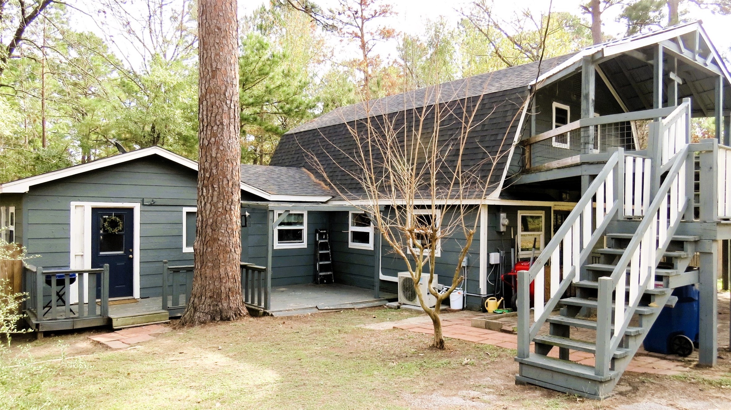 a view of a house with a patio and wooden fence