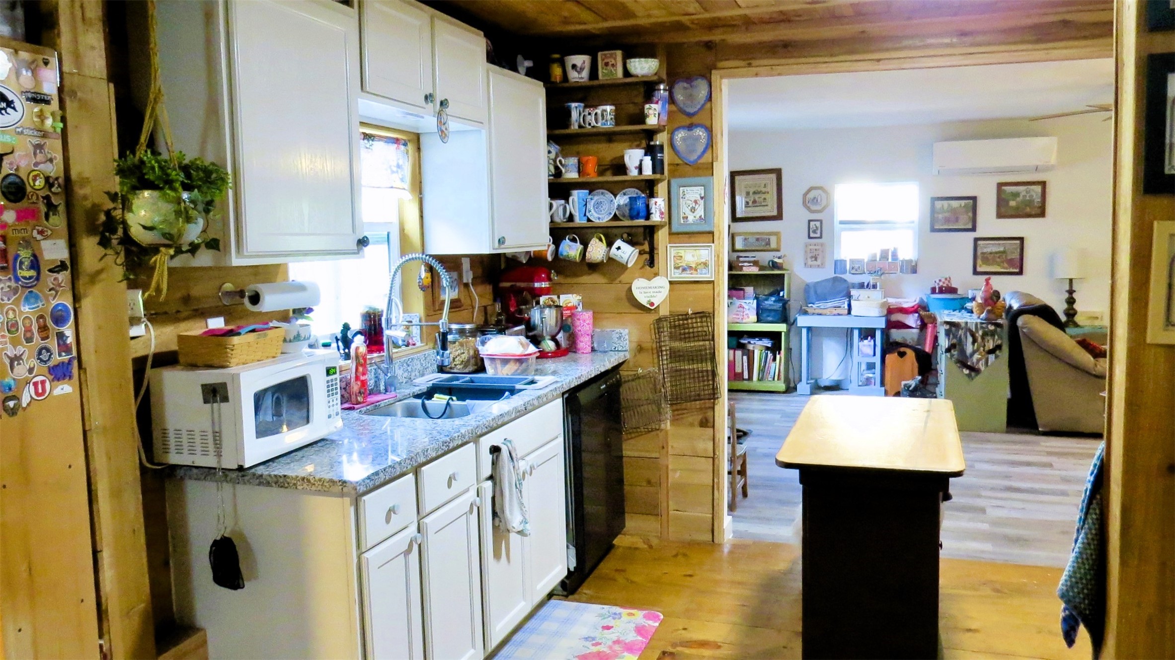 458 Rain Forest Road Onalaska, TX 77360 - Photo 18 of 35 a kitchen filled with stainless steel appliances kitchen island granite countertop a table and chairs in it