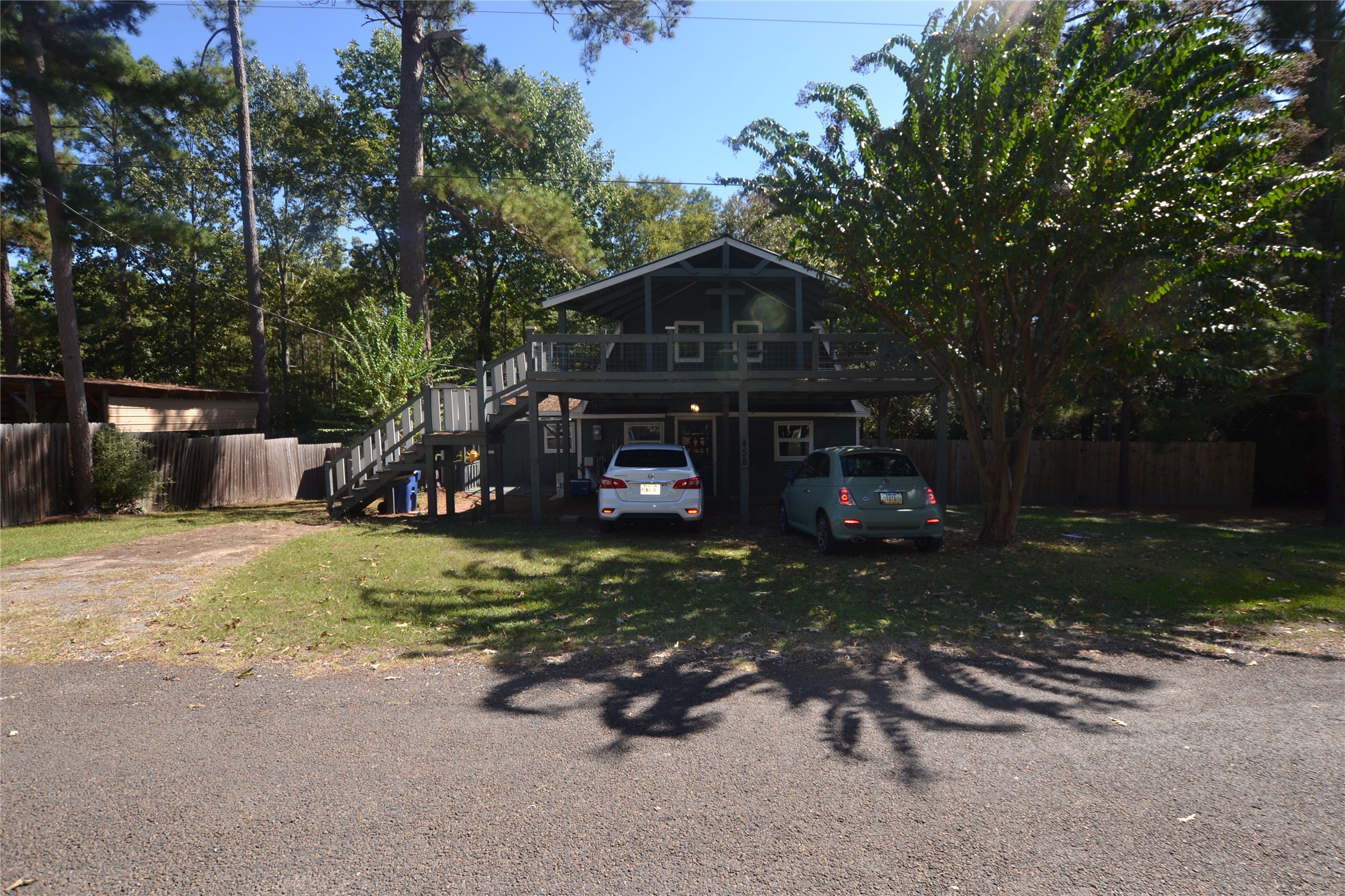 458 Rain Forest Road Onalaska, TX 77360 - Photo 2 of 25 a front view of a house with garden