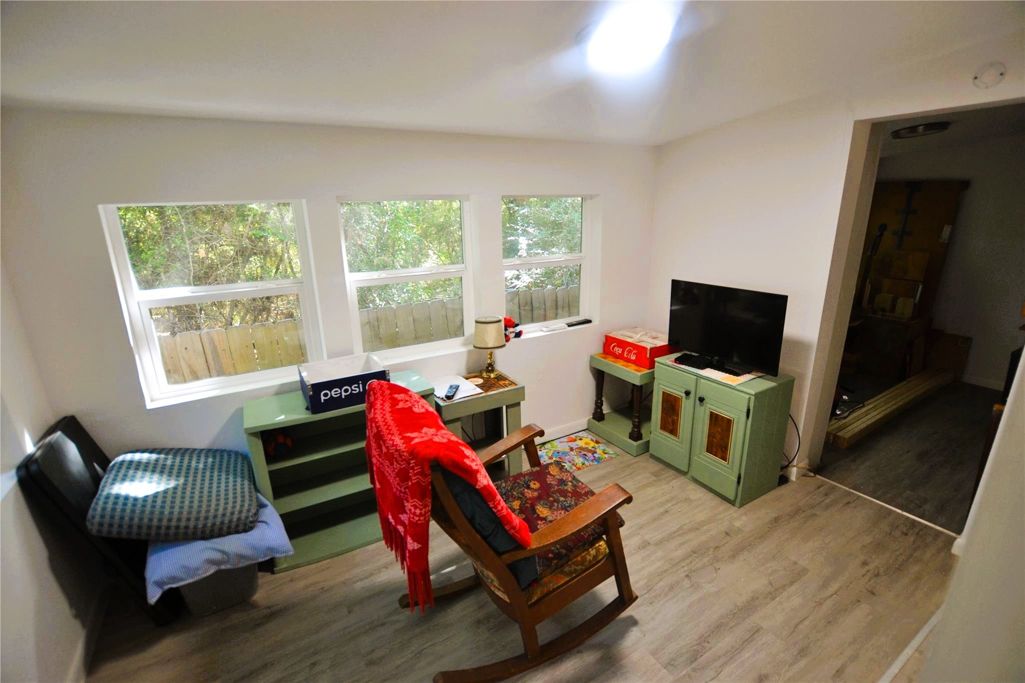458 Rain Forest Road Onalaska, TX 77360 - Photo 21 of 35 a living room with furniture a flat screen tv and a window