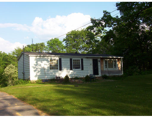 223 Keys Road Warren, MA 01585 - Photo 3 of 3 a backyard of a house with potted plants and large tree