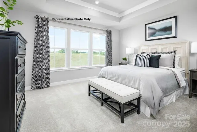 a spacious bedroom with a bed and a large window