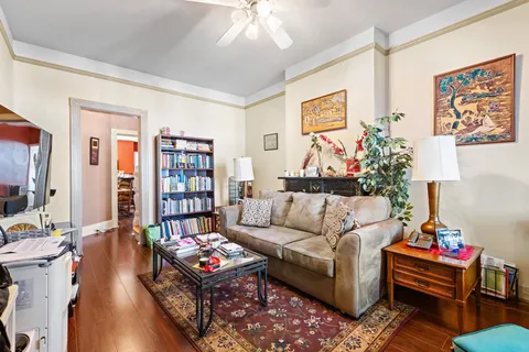 a view of a livingroom with a fireplace wooden floor and window